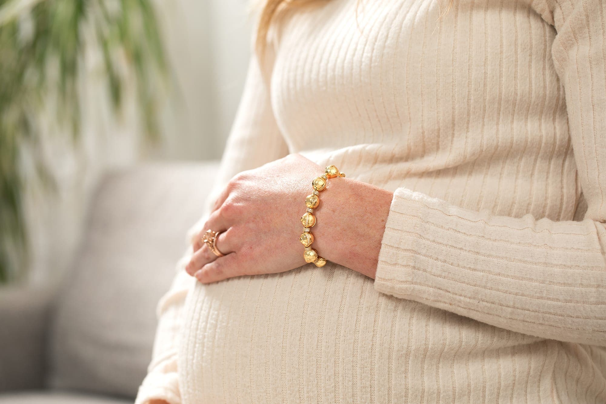 Expecting mom wearing her Charmed Beginnings pregnancy charm bracelet