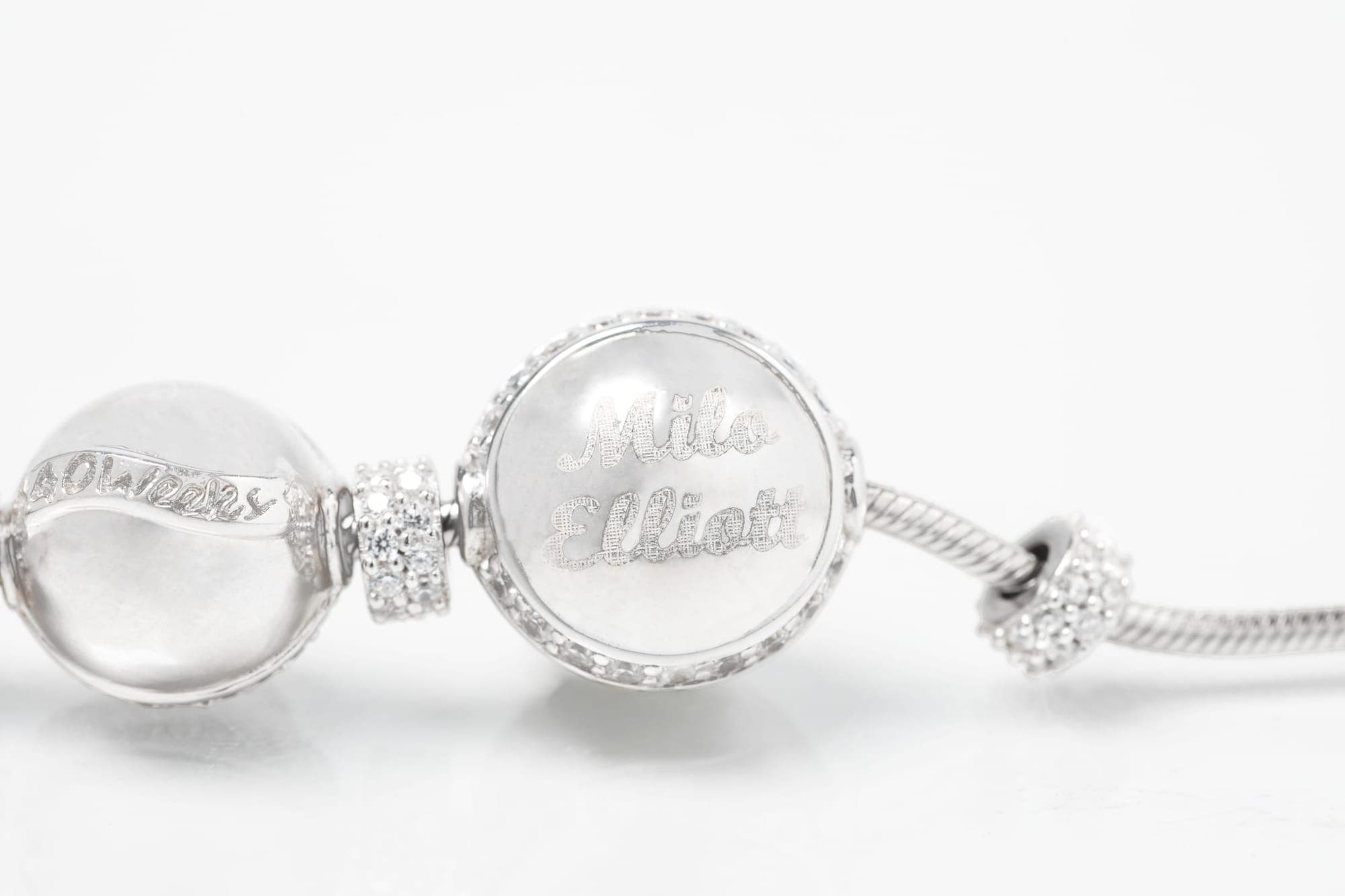 Mom wearing Charmed Beginnings bracelet with baby